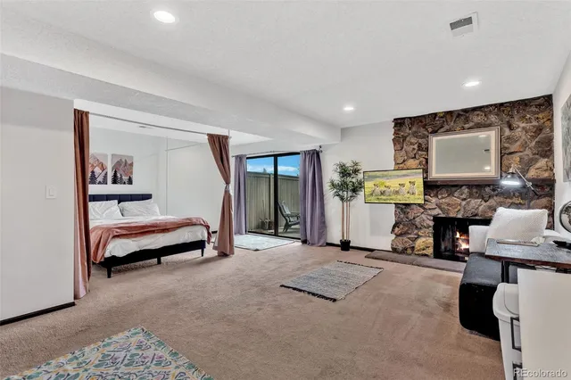 a bedroom with a bed and a painting on the wall