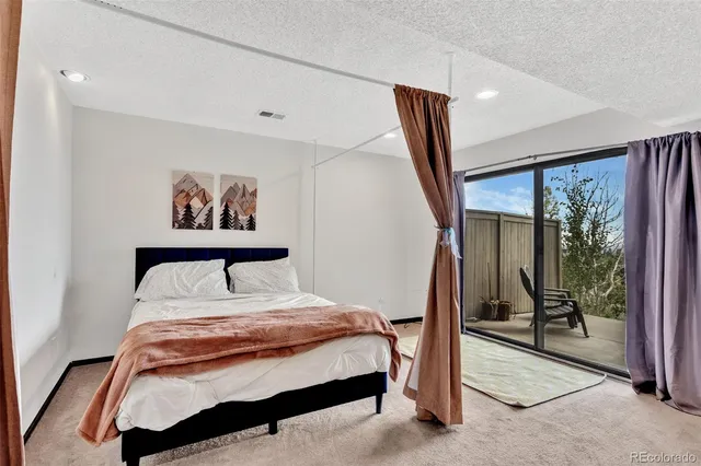 a bed room with a bed and a chair