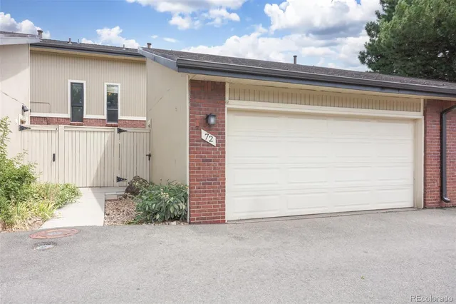 a view of a patio with table and chairs and barbeque grill