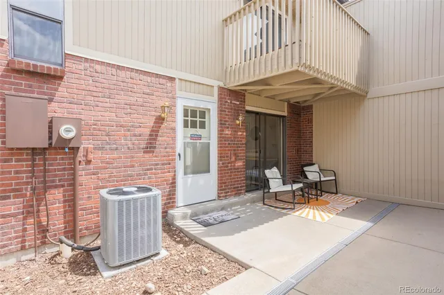 a view of a dining room with furniture a chandelier and wooden floor