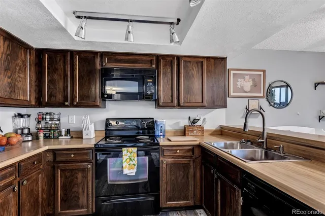 a living room with furniture a lamp wooden floor and a large window