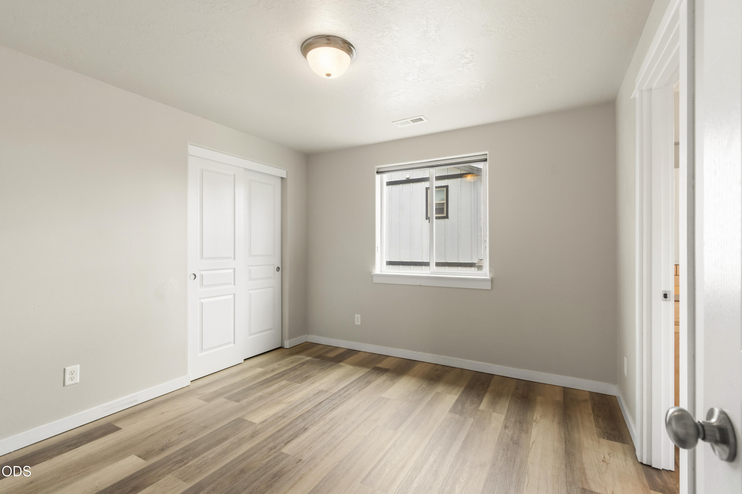 21332 Oconnor Way Bend, OR 97701 - Photo 25 of 33 an empty room with wooden floor and windows