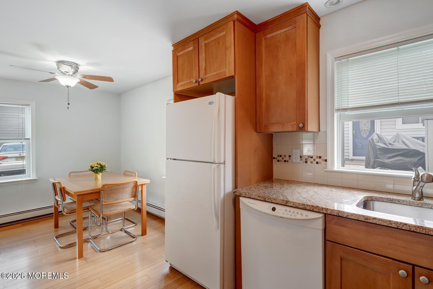 19 Shore Way Lavallette, NJ 08735 - Photo 15 of 38 a kitchen with a refrigerator a sink and cabinets