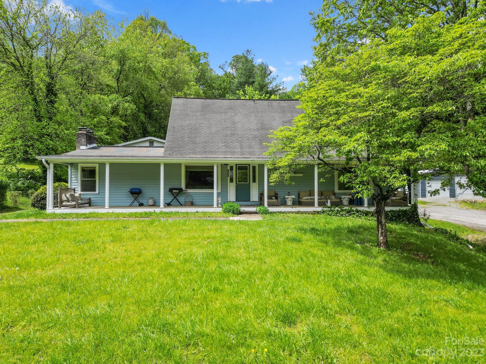 1545 Brevard Road Asheville, NC 28806 - Photo 1 of 43 a front view of a house with a garden
