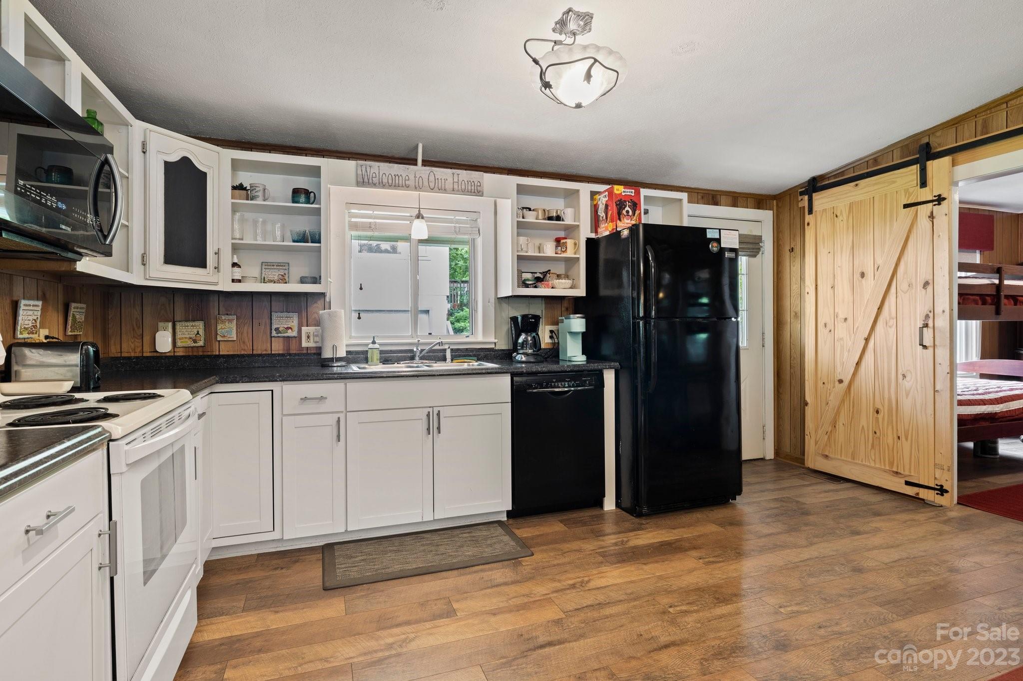 1545 Brevard Road Asheville, NC 28806 - Photo 12 of 43 a kitchen with stainless steel appliances granite countertop a refrigerator and a stove top oven