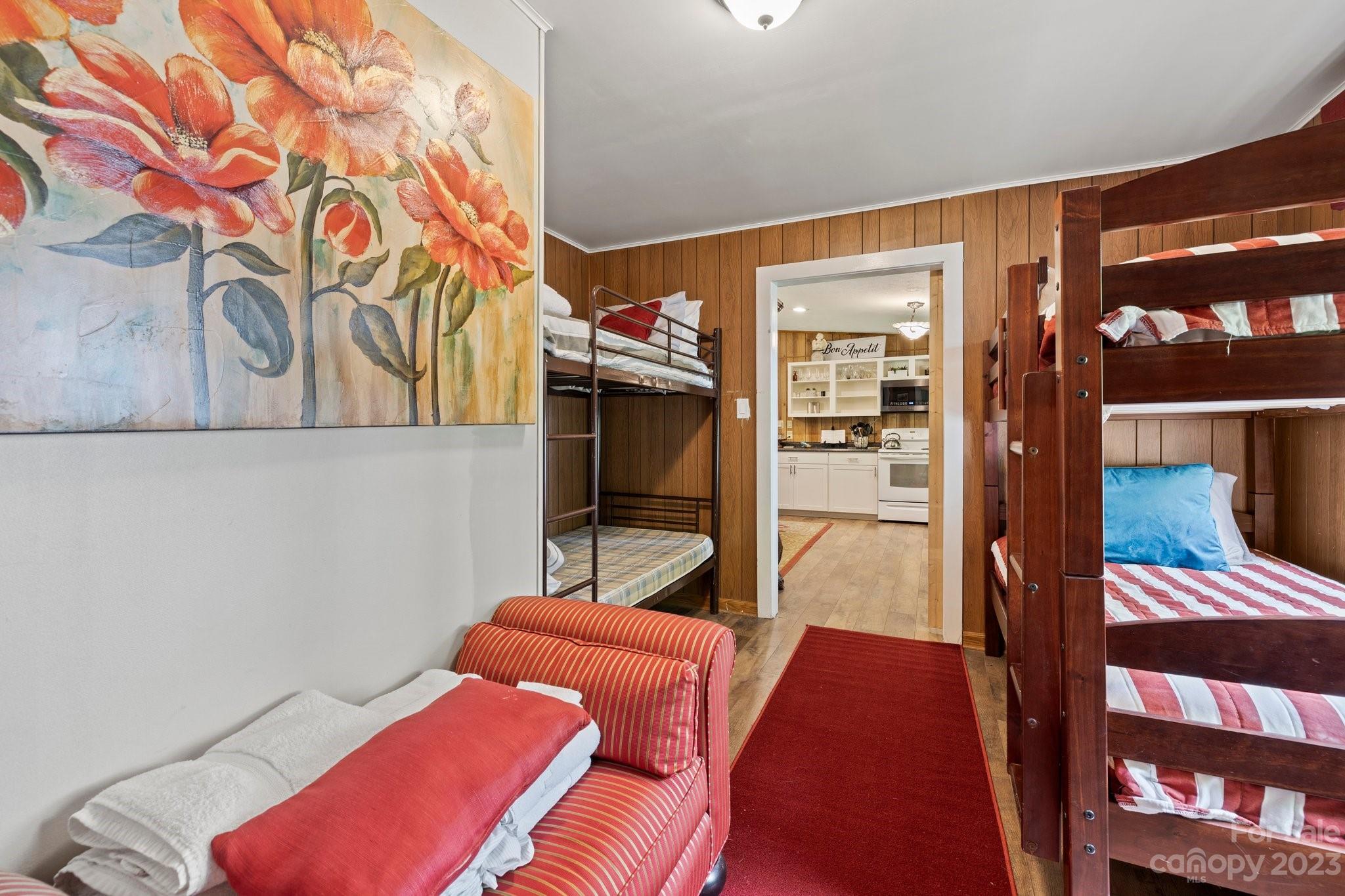 1545 Brevard Road Asheville, NC 28806 - Photo 17 of 43 a bedroom with a bed and wooden floor