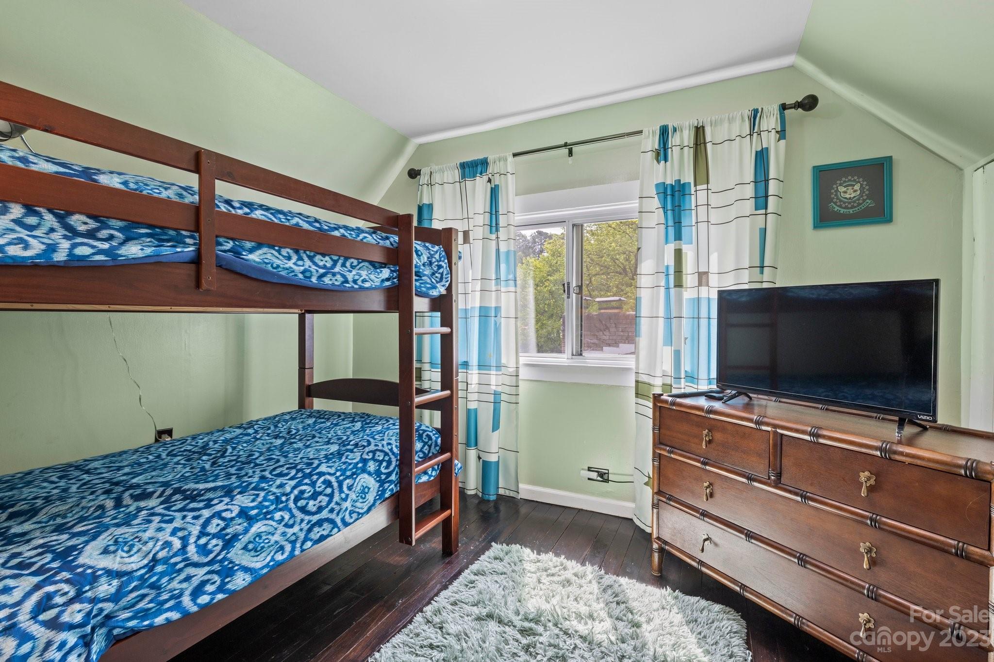 1545 Brevard Road Asheville, NC 28806 - Photo 20 of 43 a bedroom with bed and a flat tv screen on dresser