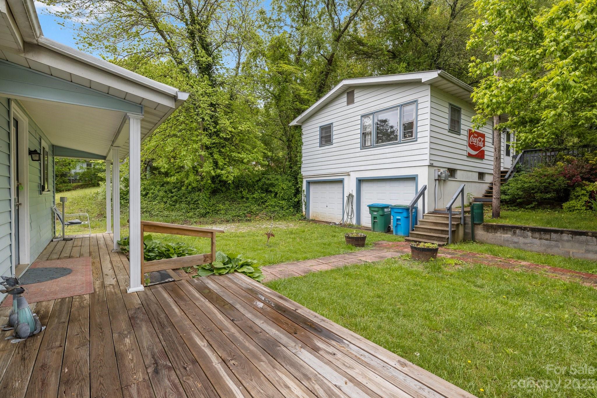 1545 Brevard Road Asheville, NC 28806 - Photo 25 of 43 a view of a house with backyard sitting area and garden