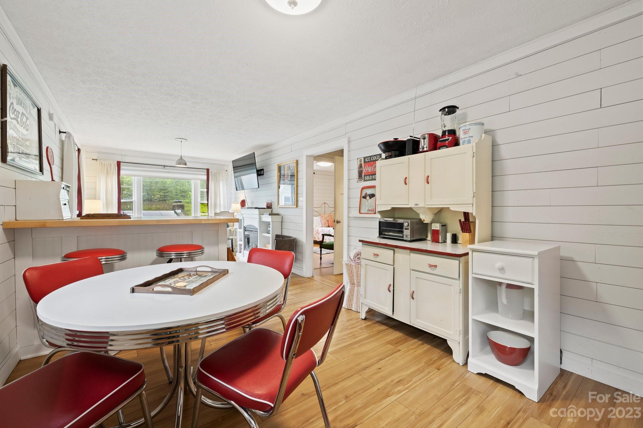 1545 Brevard Road Asheville, NC 28806 - Photo 28 of 43 a kitchen with a dining table cabinets and appliances