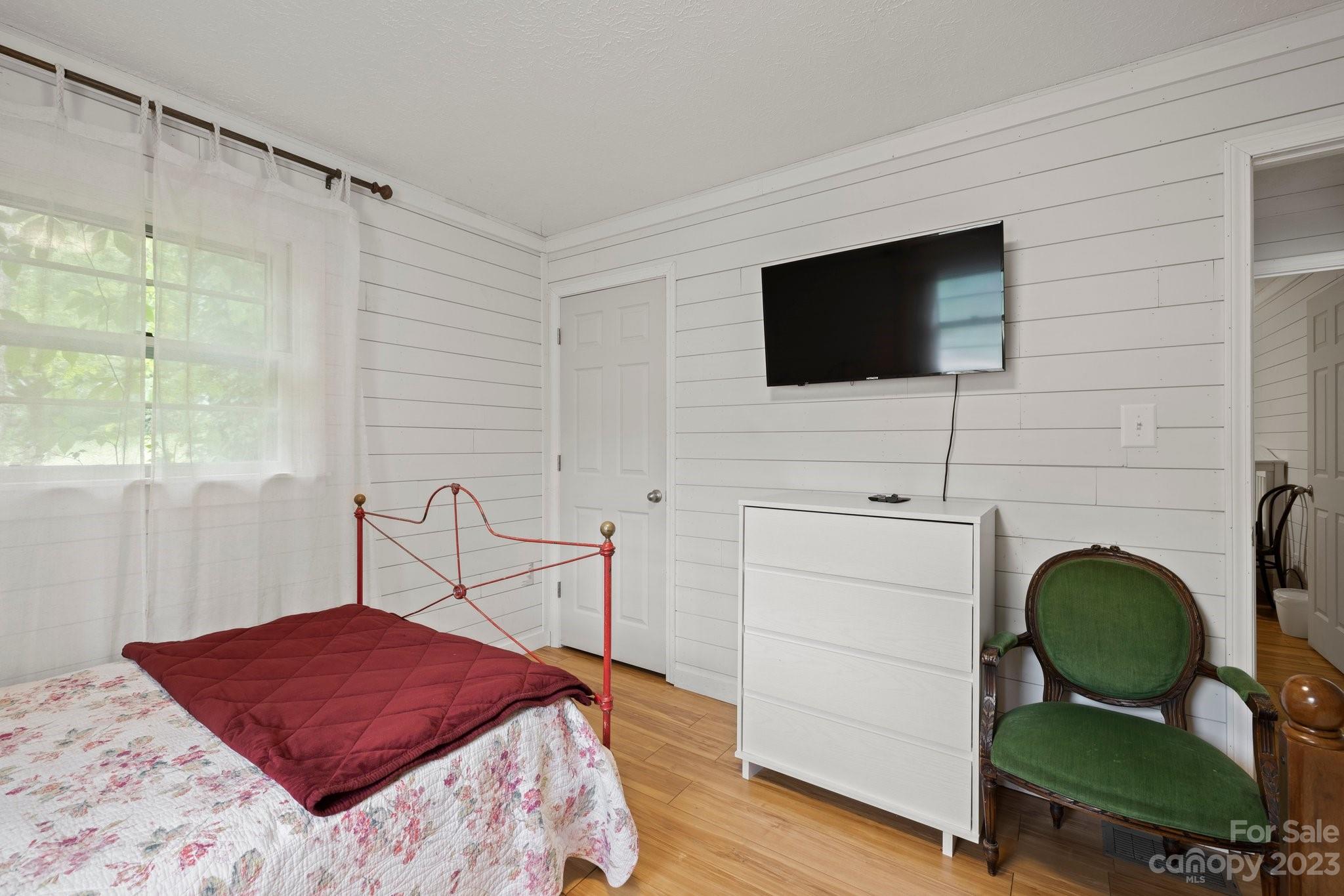 1545 Brevard Road Asheville, NC 28806 - Photo 34 of 43 a bedroom with a bed and a flat screen tv
