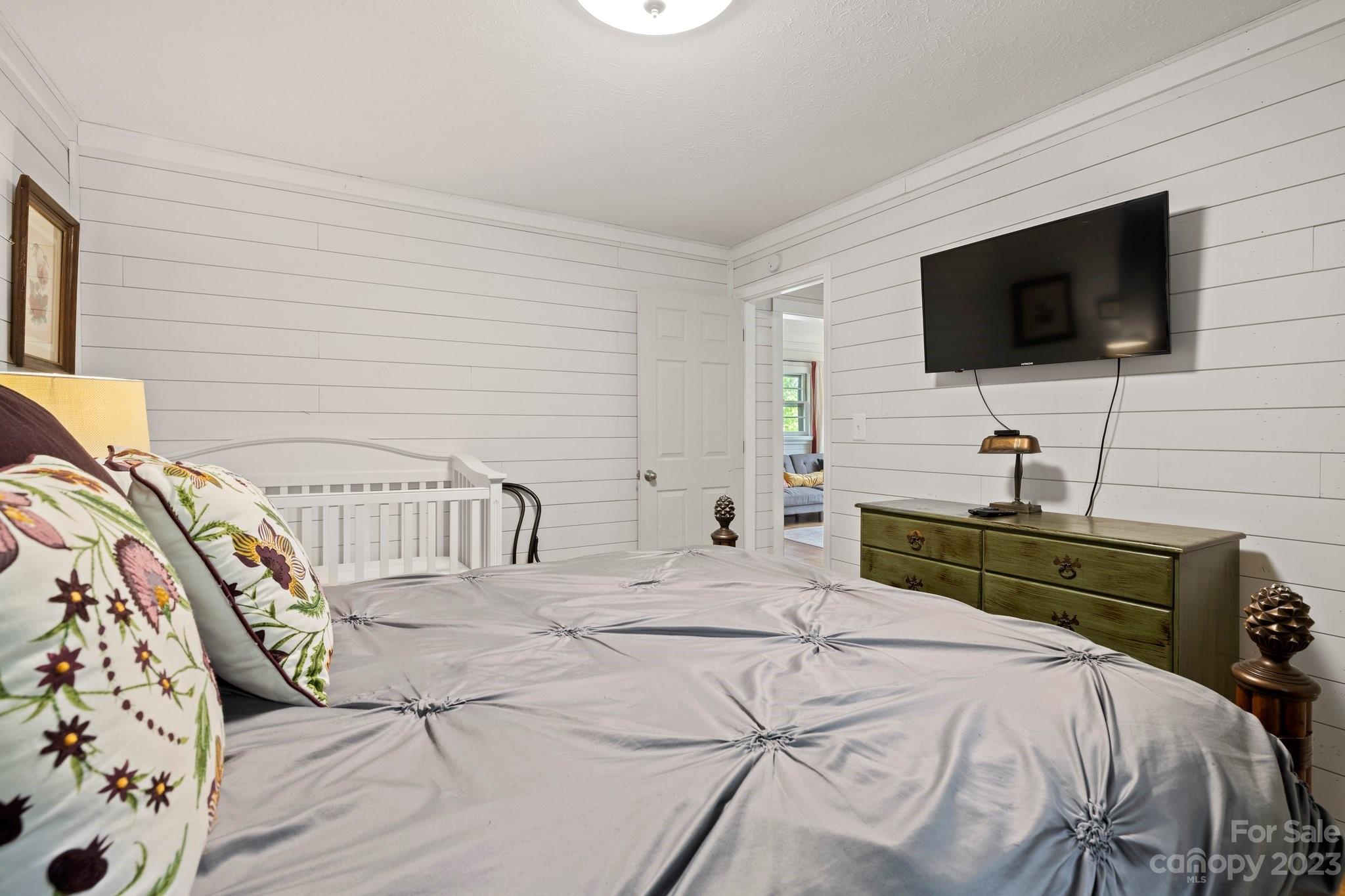 1545 Brevard Road Asheville, NC 28806 - Photo 36 of 43 a bedroom with a bed and a flat screen tv