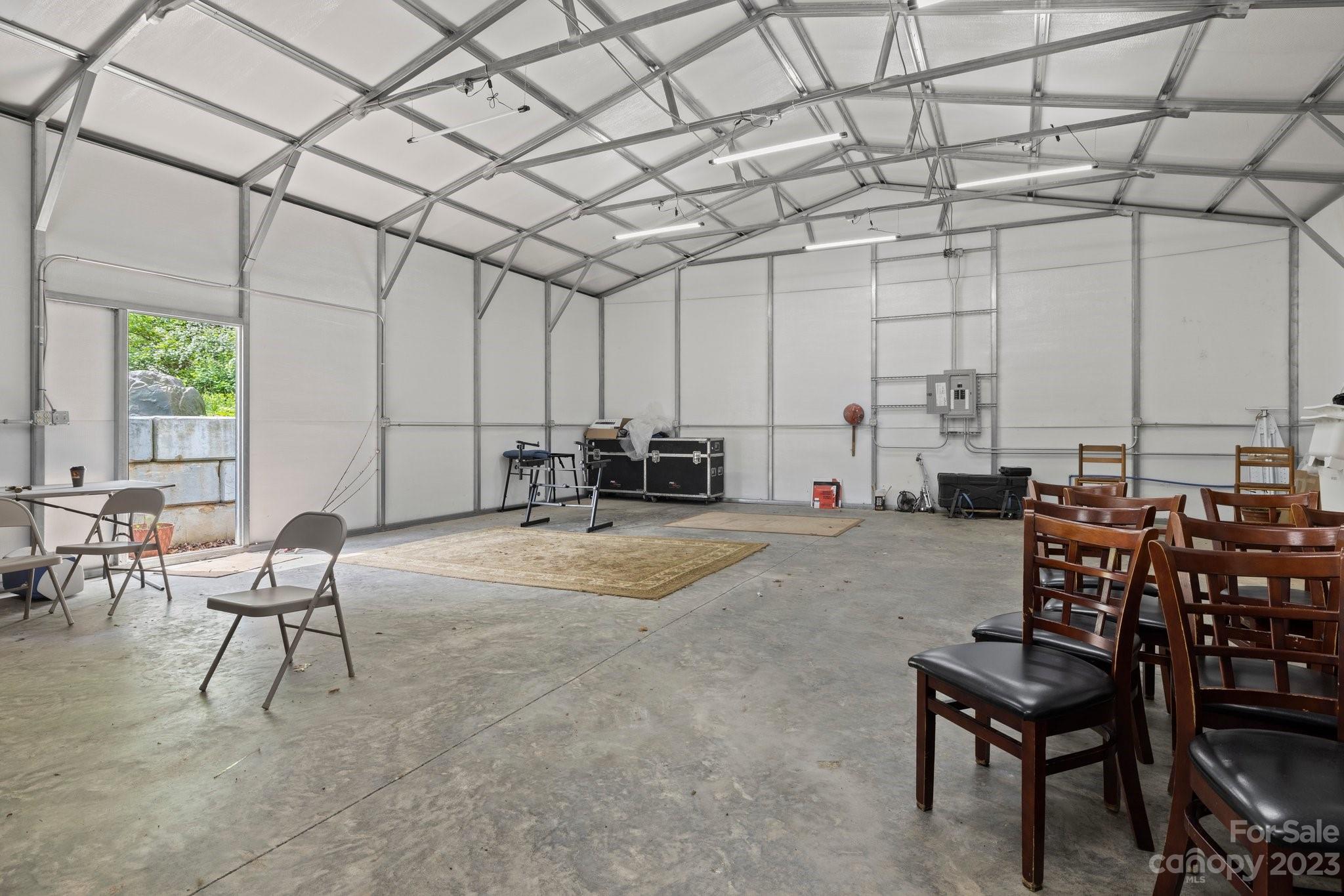 1545 Brevard Road Asheville, NC 28806 - Photo 39 of 43 a living room with lots of furniture and a chandelier