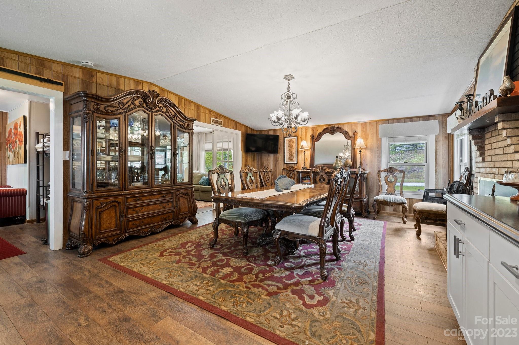 1545 Brevard Road Asheville, NC 28806 - Photo 10 of 43 a living room with furniture a rug and a chandelier