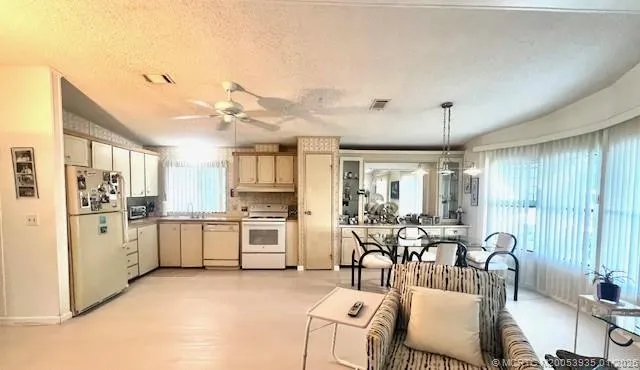 a large kitchen with cabinets table and chairs
