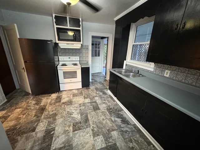 a kitchen with stainless steel appliances a refrigerator and a sink