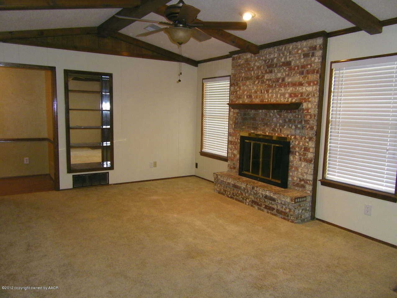 5714 South Milam Street Amarillo, TX 79110 - Photo 2 of 22 an empty room with furniture and a fireplace