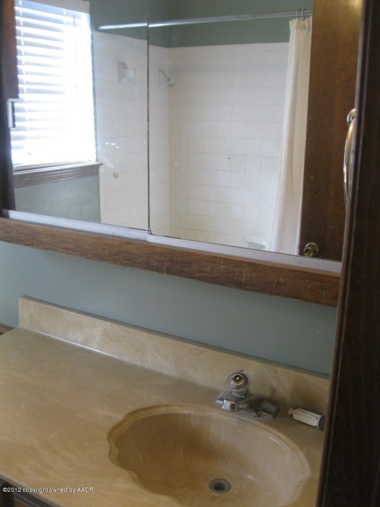 5714 South Milam Street Amarillo, TX 79110 - Photo 11 of 22 a bathroom with a sink and a window
