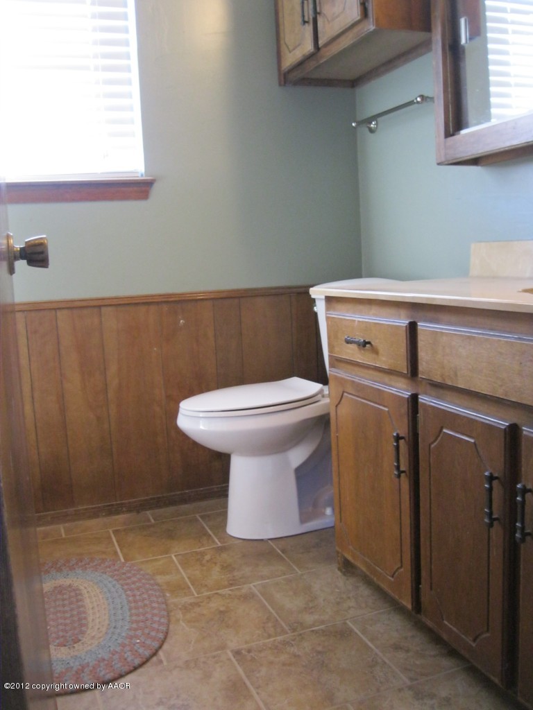 5714 South Milam Street Amarillo, TX 79110 - Photo 13 of 22 a bathroom with a toilet and a sink