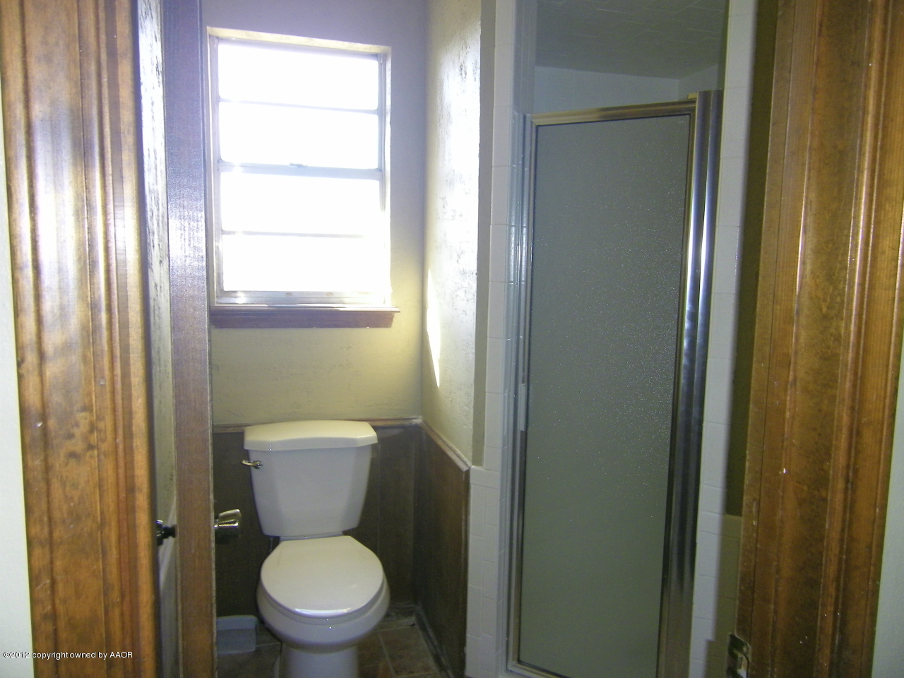5714 South Milam Street Amarillo, TX 79110 - Photo 18 of 22 a white toilet sitting next to a bathroom