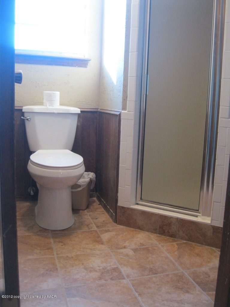 5714 South Milam Street Amarillo, TX 79110 - Photo 19 of 22 a bathroom with a toilet and a sink