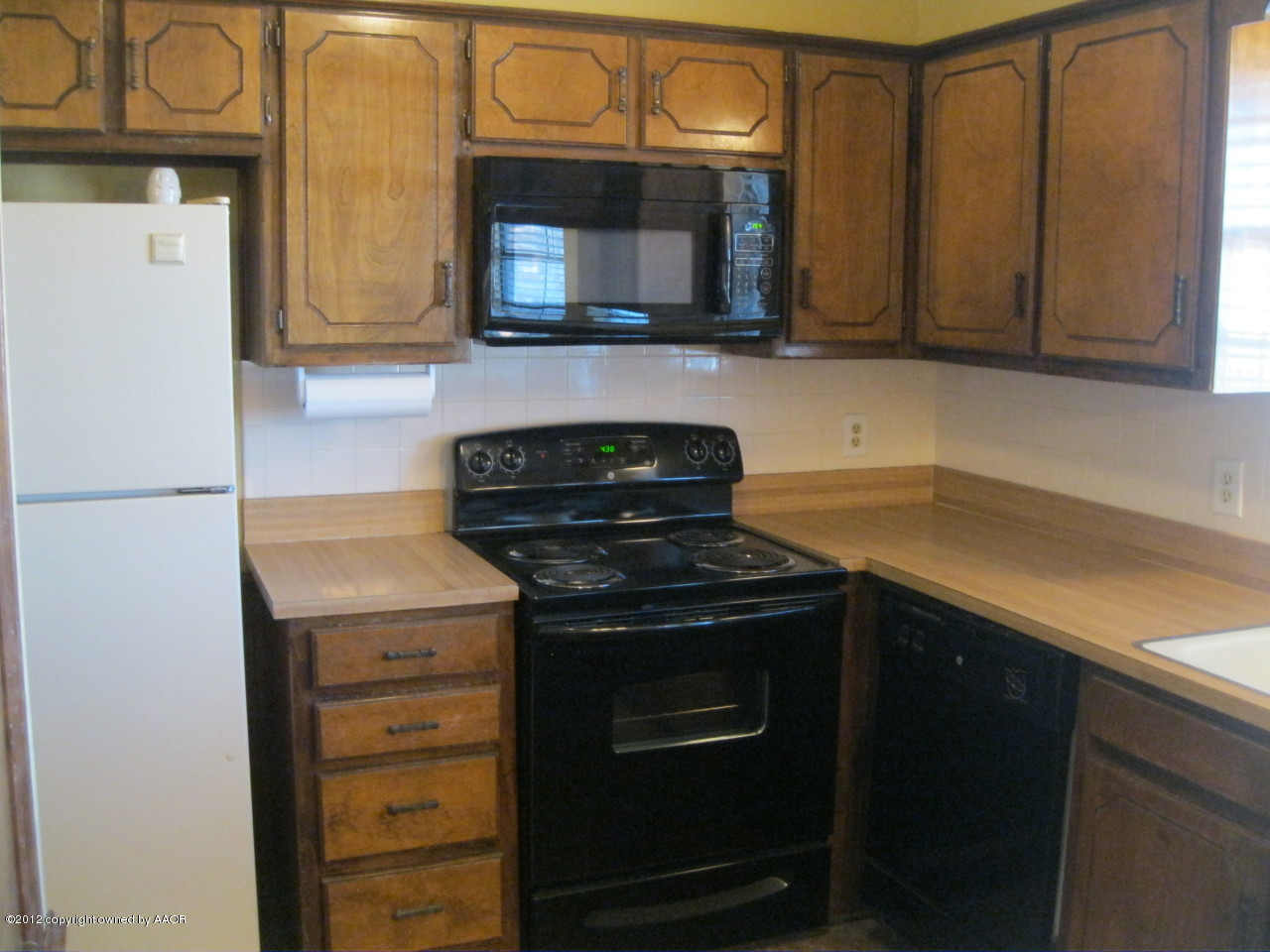 5714 South Milam Street Amarillo, TX 79110 - Photo 7 of 22 a kitchen with stainless steel appliances granite countertop a stove microwave and refrigerator