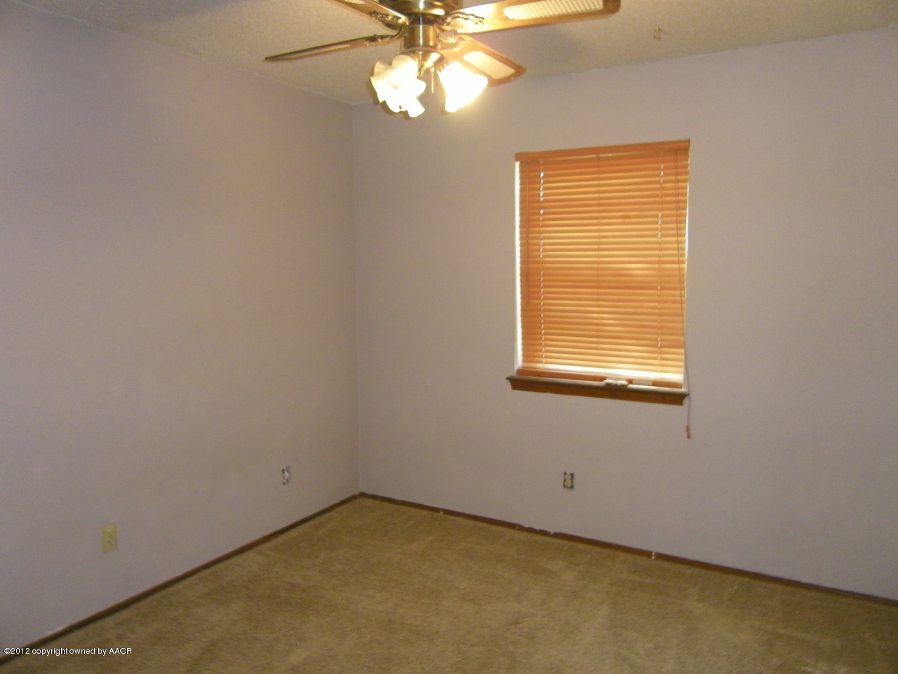 5714 South Milam Street Amarillo, TX 79110 - Photo 9 of 22 an empty room with windows and chandelier fan