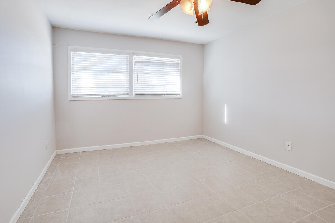 2123 66th Street Lubbock, TX 79412 - Photo 15 of 16 an empty room with a window and a ceiling fan