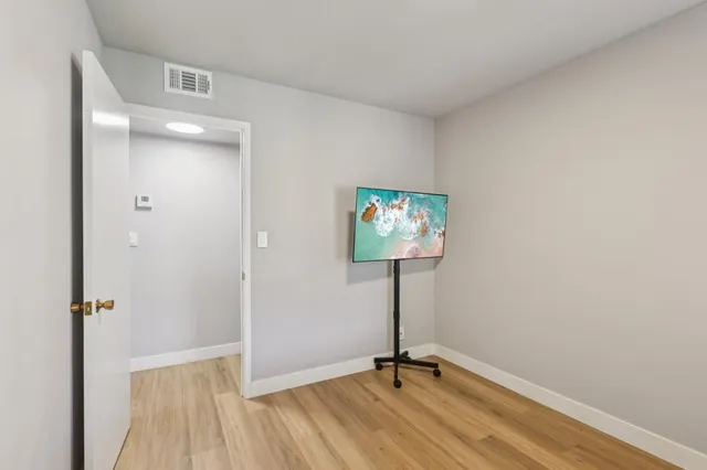 a view of a room with a flat screen tv