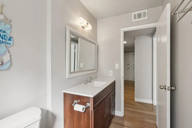 a bathroom with a sink toilet and mirror
