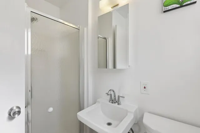 a bathroom with a toilet a sink and mirror