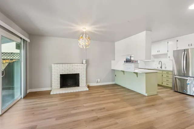 a kitchen with a refrigerator and a fireplace