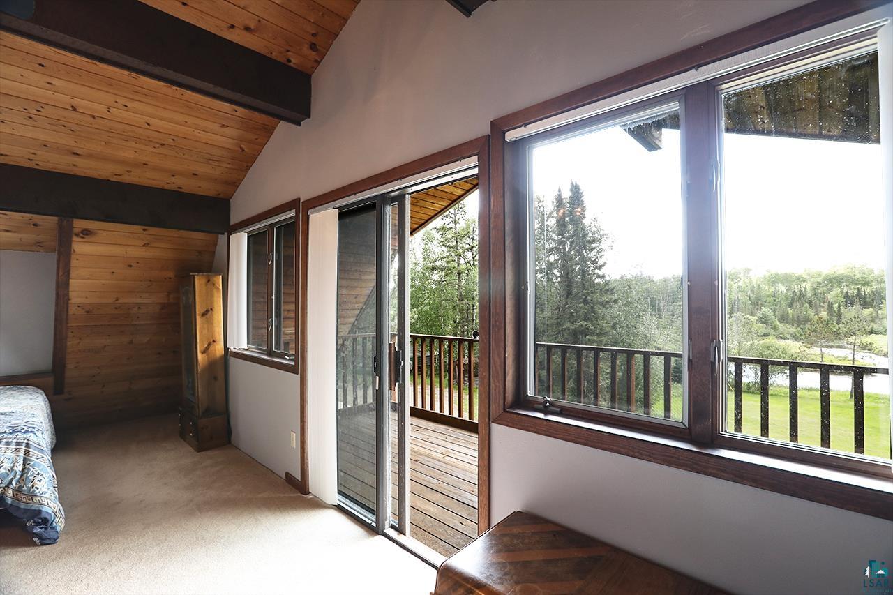 9289 Heino Road Angora, MN 55703 - Photo 12 of 37 Vaulted wood-paneled ceiling with exposed beams