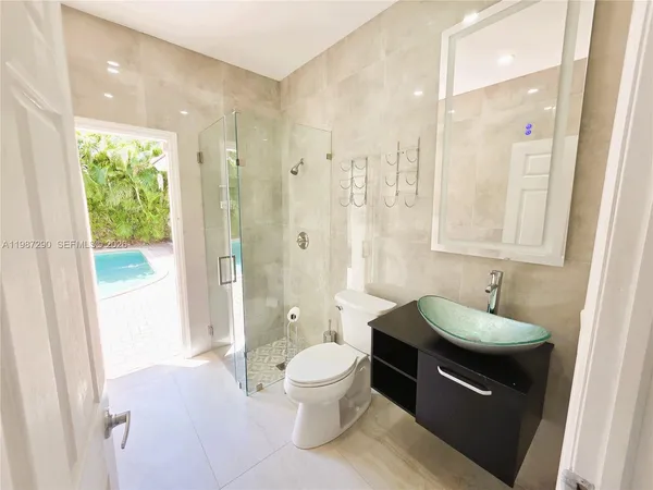 a bathroom with a bathtub toilet and shower