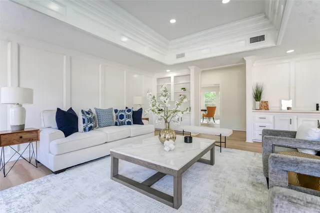 a living room with furniture and a kitchen view