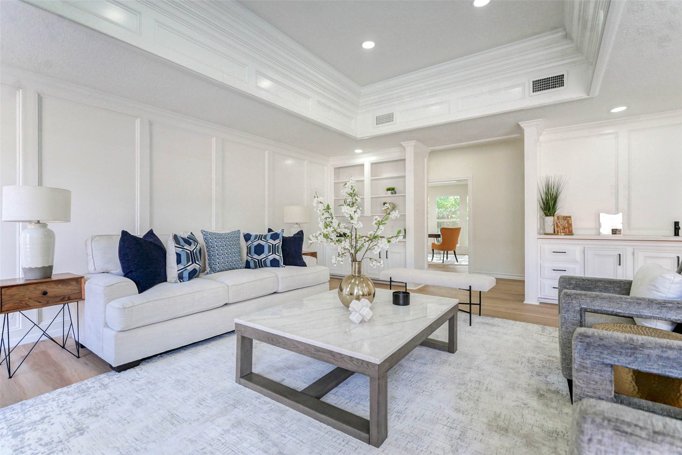 a living room with furniture and a kitchen view