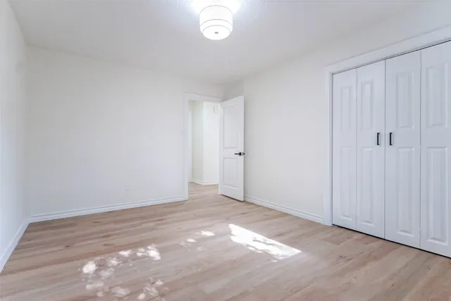a view of an empty room and wooden floor