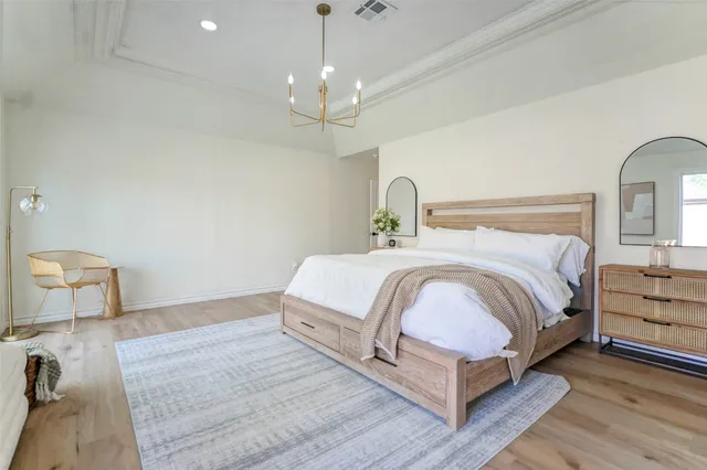 a bed room with a bed and a chandelier