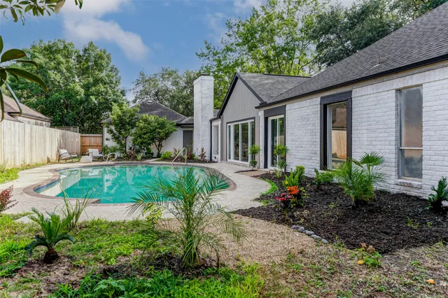 a view of a house with a yard and potted plants