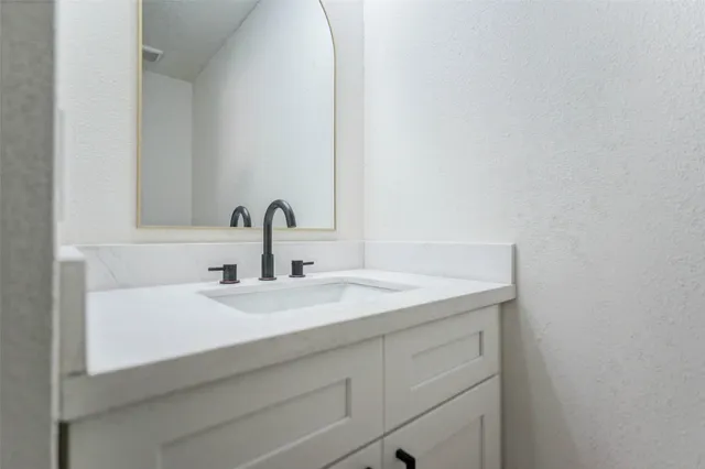 a bathroom with a sink and vanity