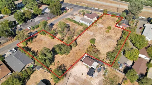an aerial view of a house with a yard and garden