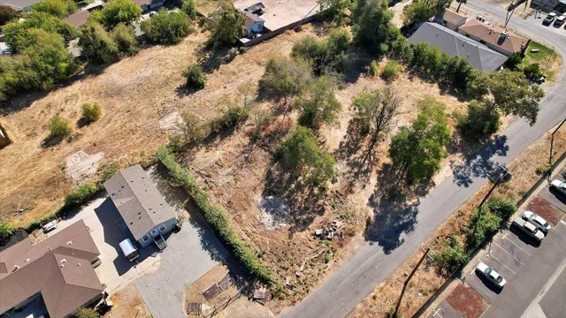 an aerial view of a house with a yard