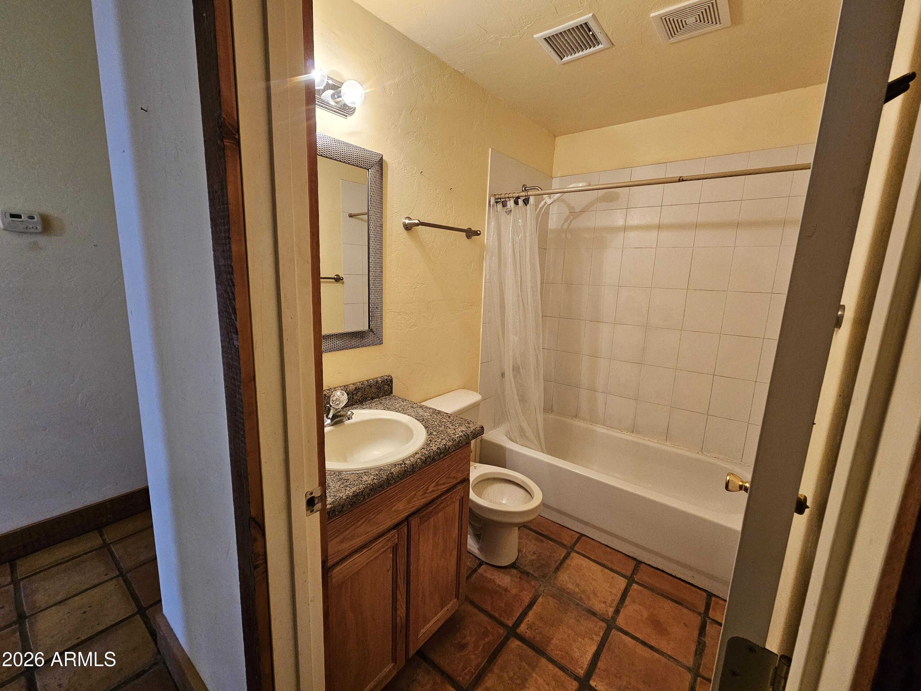 4105 North Washington Avenue Douglas, AZ 85607 - Photo 40 of 61 a bathroom with a sink a toilet a mirror and shower