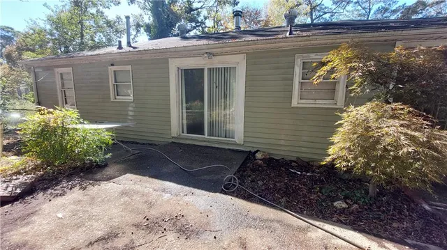 a front view of a house with a yard and potted plants