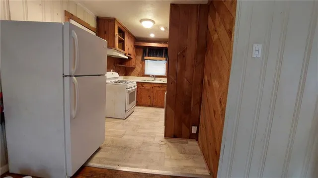 a room with a refrigerator and a sink