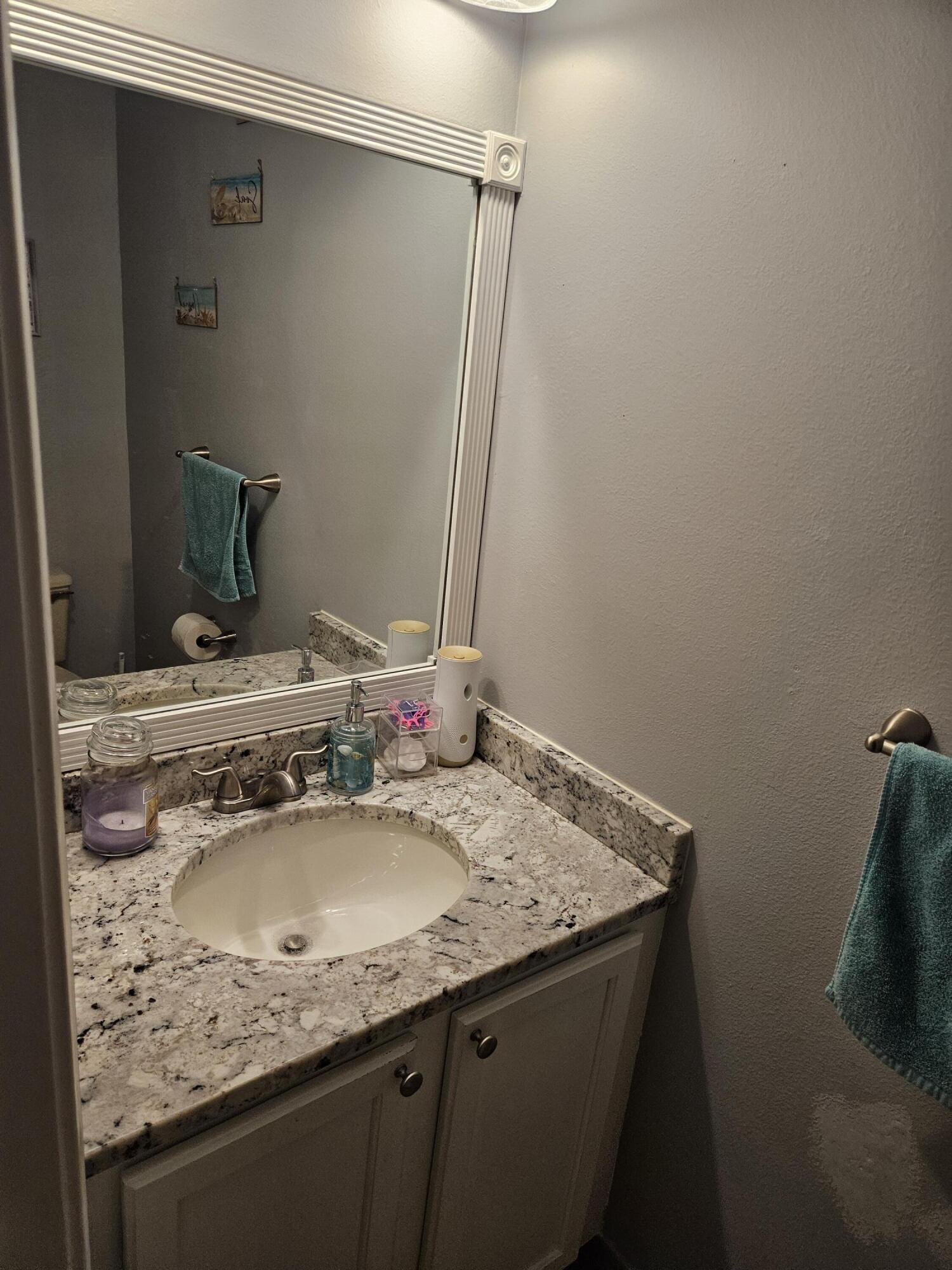 8027 Big Pine Way Riviera Beach, FL 33407 - Photo 5 of 6 a bathroom with a granite countertop sink and a mirror