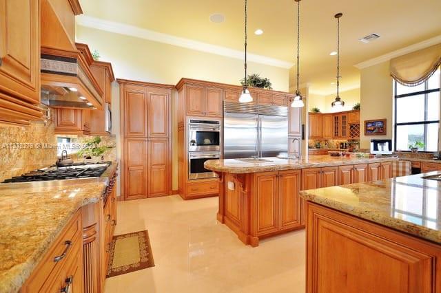 19349 Waters Edge Street Weston, FL 33332 - Photo 3 of 63 a kitchen with stainless steel appliances granite countertop a stove a sink and a refrigerator