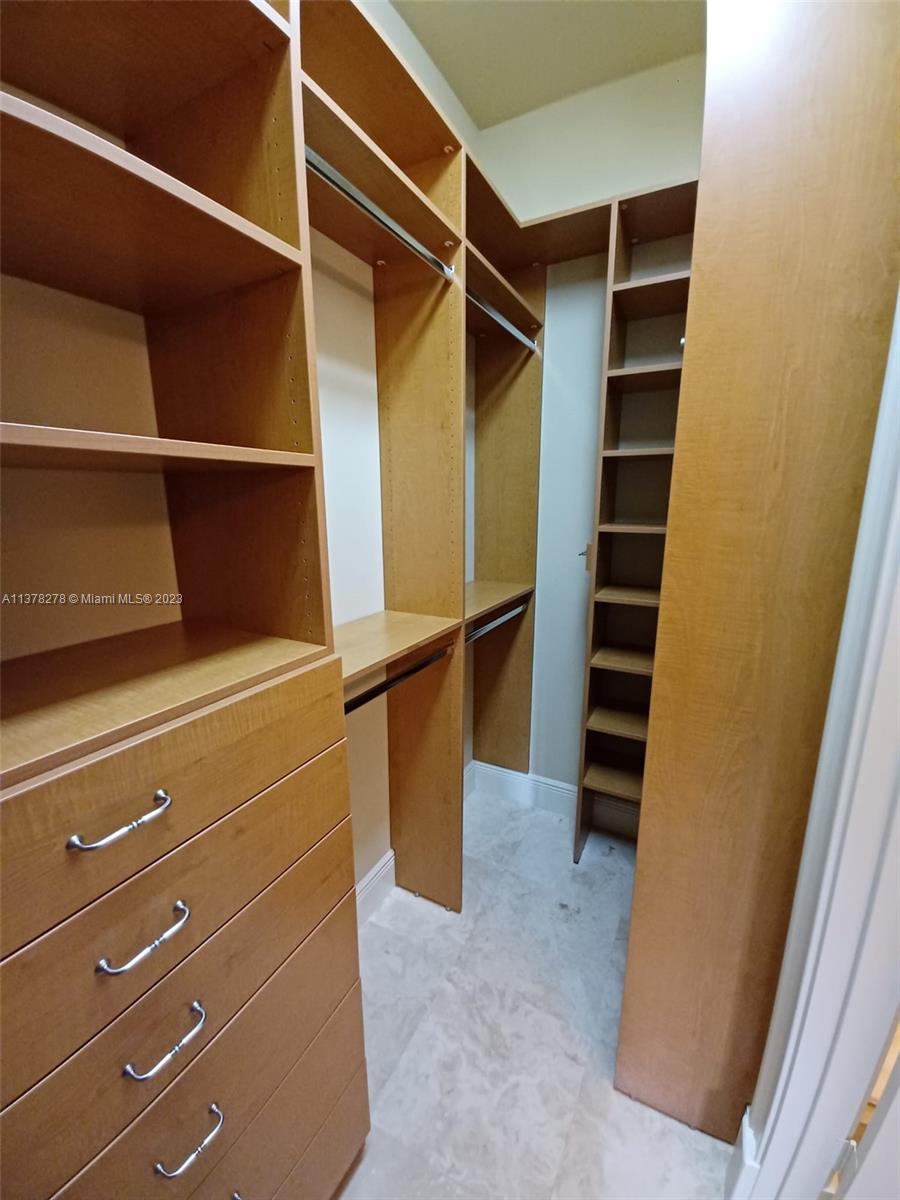 19349 Waters Edge Street Weston, FL 33332 - Photo 34 of 63 a view of walk in closet with stairs