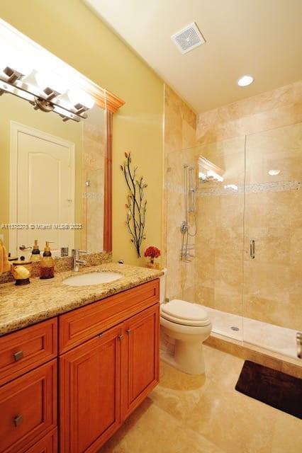 19349 Waters Edge Street Weston, FL 33332 - Photo 35 of 63 a bathroom with a granite countertop sink a toilet a mirror and bathtub