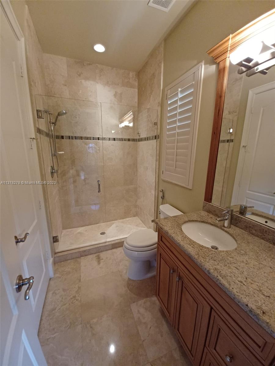 19349 Waters Edge Street Weston, FL 33332 - Photo 37 of 63 a bathroom with a granite countertop sink a toilet and shower