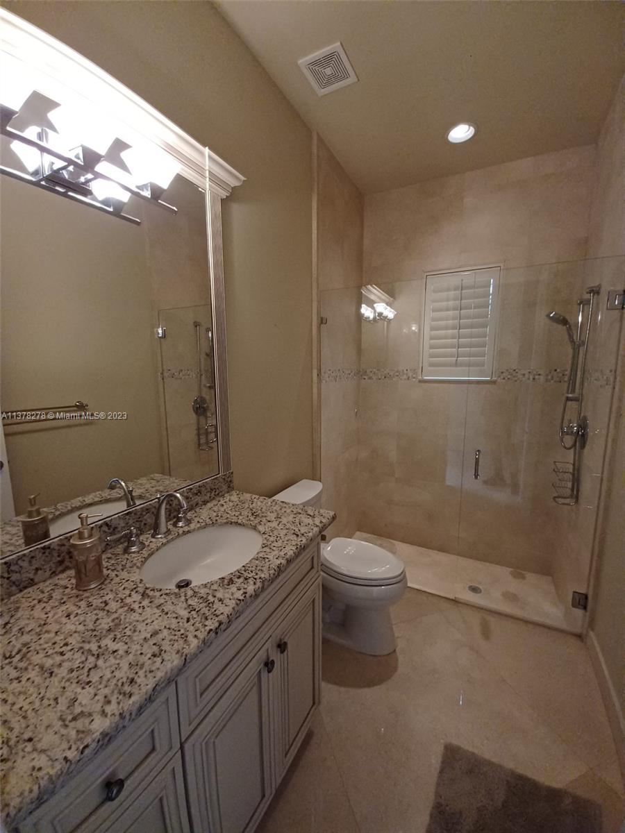 19349 Waters Edge Street Weston, FL 33332 - Photo 38 of 63 a bathroom with a granite countertop sink a toilet and shower
